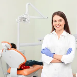 Emergency dentist in Edison standing beside a patient in a modern dental treatment room.